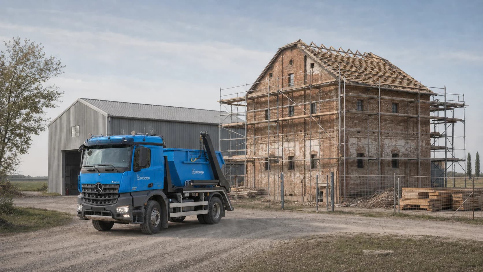 Entsorgo container truck outside a farm building undergoing renovation