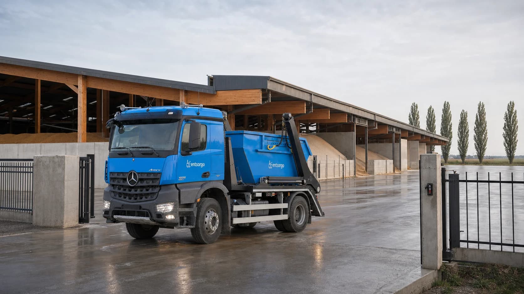 Entsorgo container truck in the wet yard of a modern agricultural site