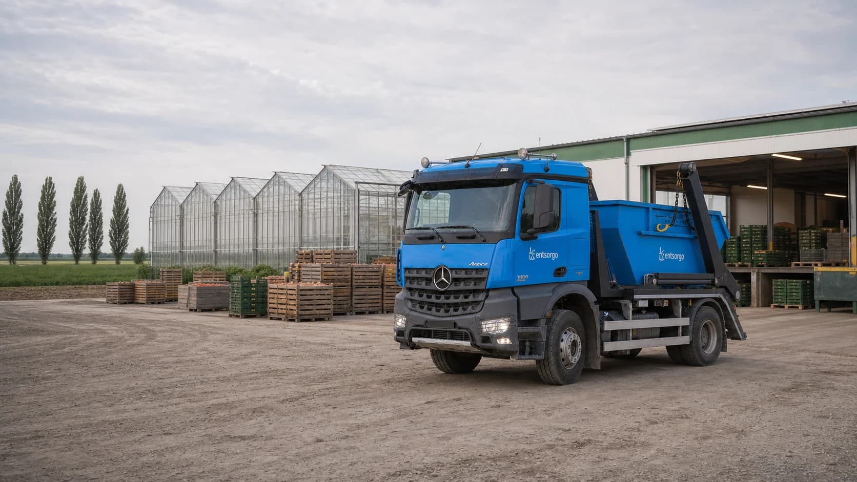 Entsorgo container truck outside an agricultural packing facility and greenhouses