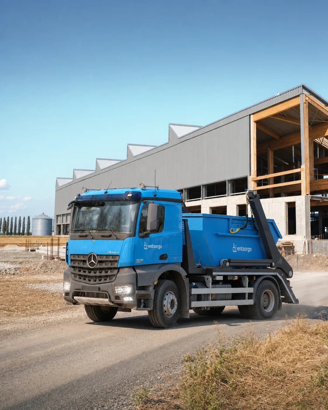 Entsorgo container truck outside an agricultural building under renovation on the Hungarian Great Plain